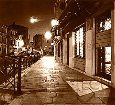 Sepia photo of the Fondamenta Minotto in the Santa Croce sestiere of Venice shot at night revealing the elements of Venetian urban design