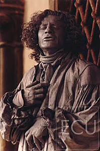 Color photo of a man dressed as Beethoven in front of the Doges Palace near Piazza San Marco during Carnevale in Venice, Italy