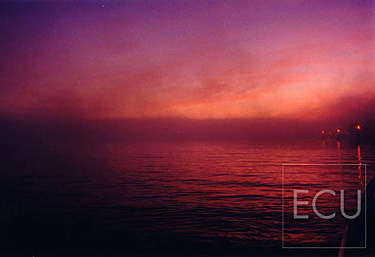 Color photograph of Laguna from vaporetto heading to Fondamenta Nouve in winter in fog at sunset in Venice, Italy rendered in an impressionistic style